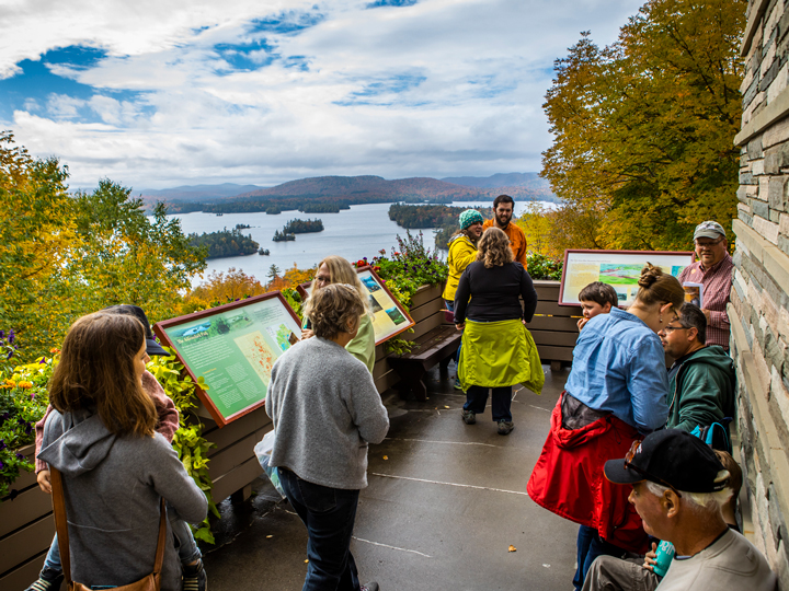 Visitors taking in the expansive view of Blue Mountain Lake in the Fall.