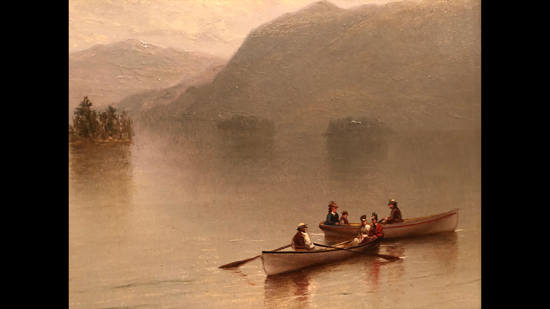 A cropped view of a painting depicting two boats out on the water in the Adirondacks.