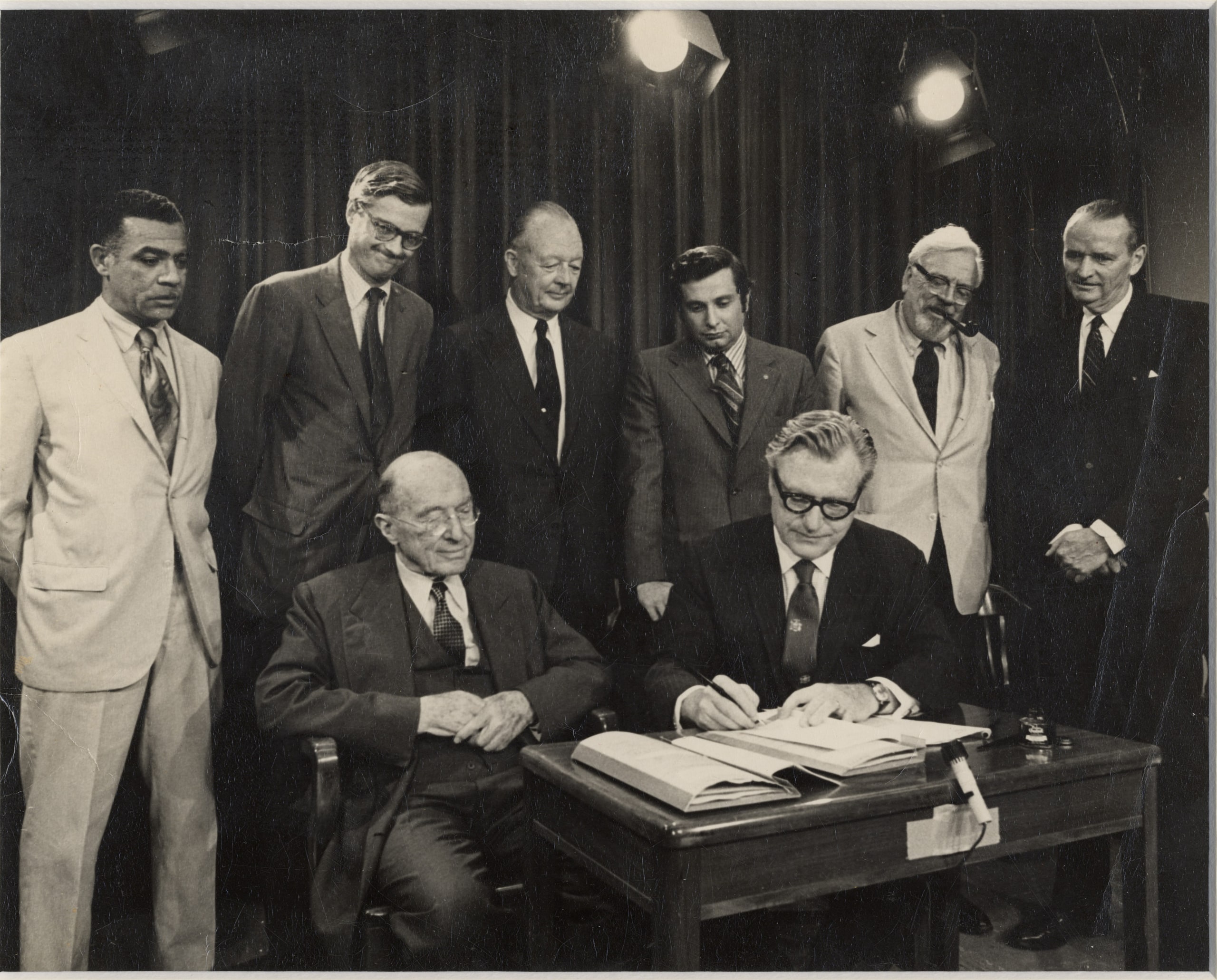 Gov. Nelson Rockefeller signs the Adirondack Park Agency Act on June 22, [sic] 1971 as commissioners (left to right) Fred O’Neal, Peter Paine, Stewart Kilbourne, Henry Diamond, Robert Hall, Richard Lawrence and (seated) Chairman Harold Hochschild look on. New York State photo from the collection of the Lake George Mirror