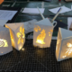 A table with four white boxes, each containing a lighted design.