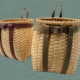 Two baskets with straps are displayed, one brown and one tan.
